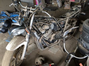 埃まみれでフレームがむき出しになったCB400SF VTEC2の前方、倉庫で放置されていたバイク